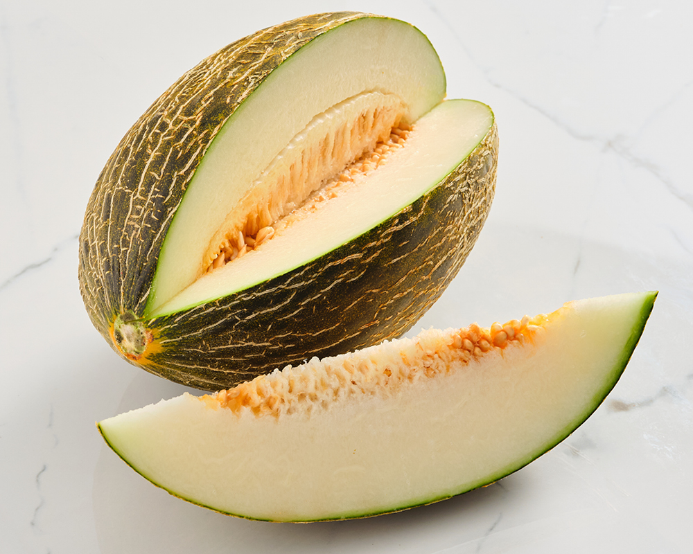 Santa Claus melon with cut wedge