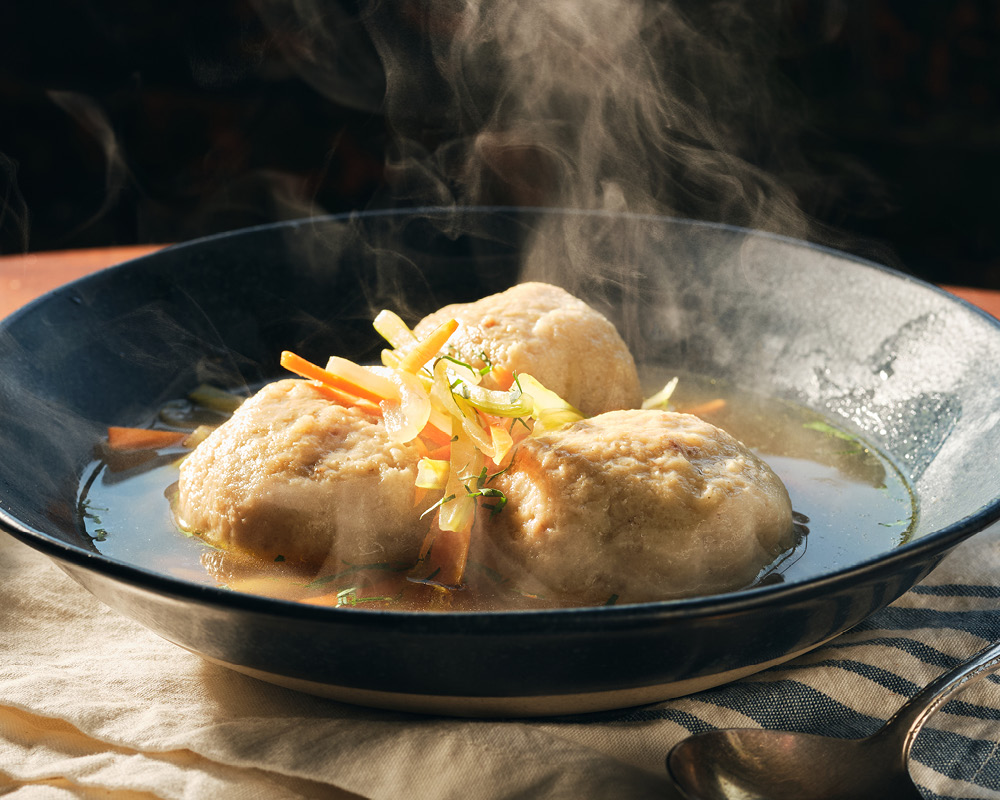 Steaming bowl of matzo ball soup
