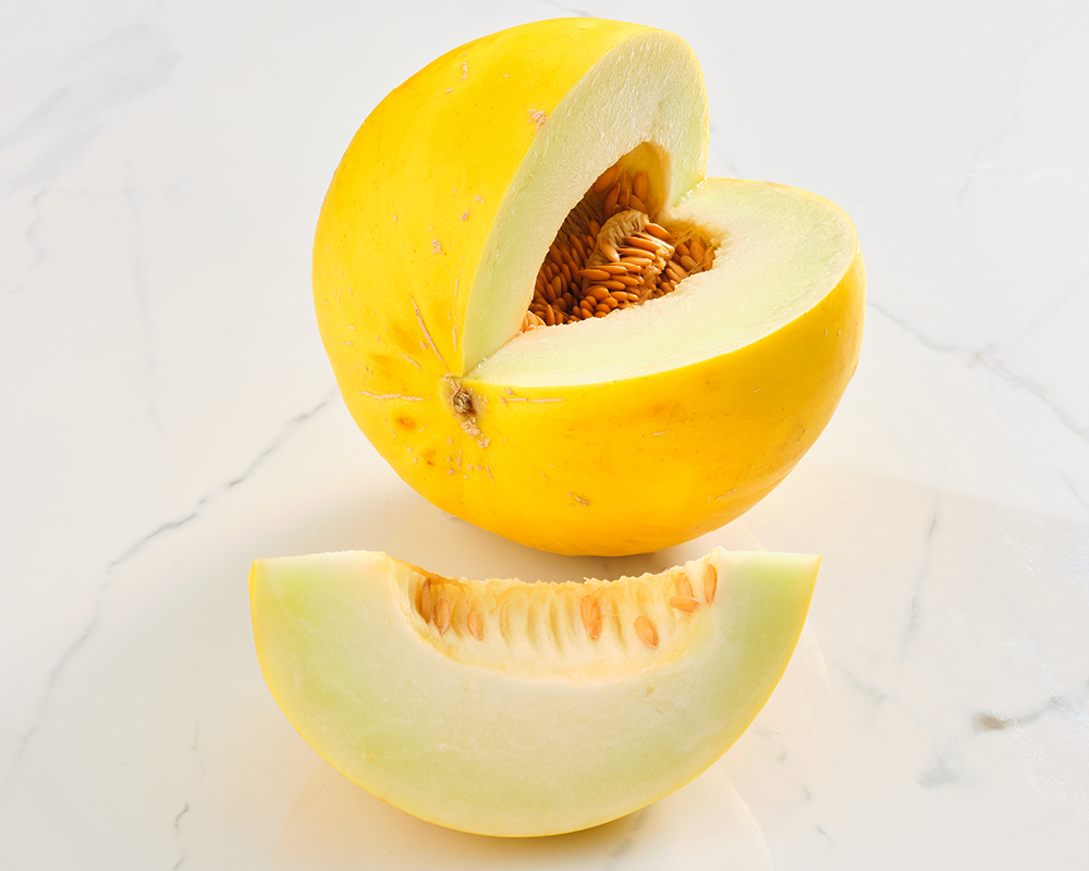 Golden honeydew melon with cut wedge