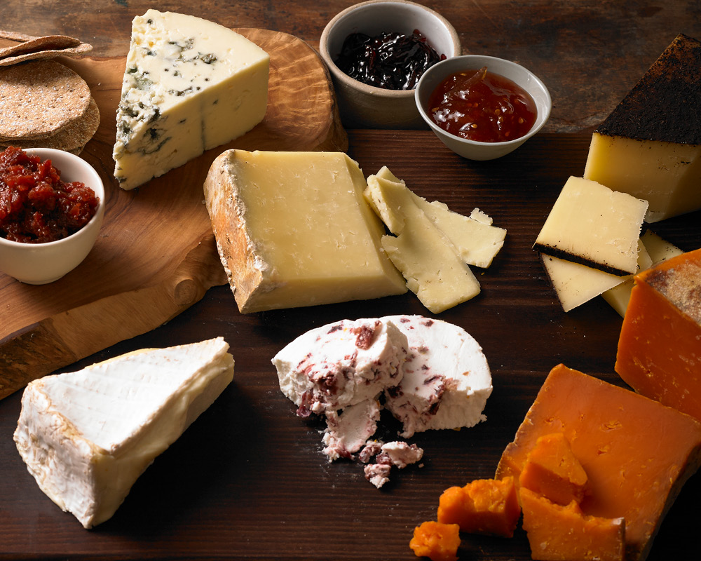 A grazing spread with different cheeses and accompaniments