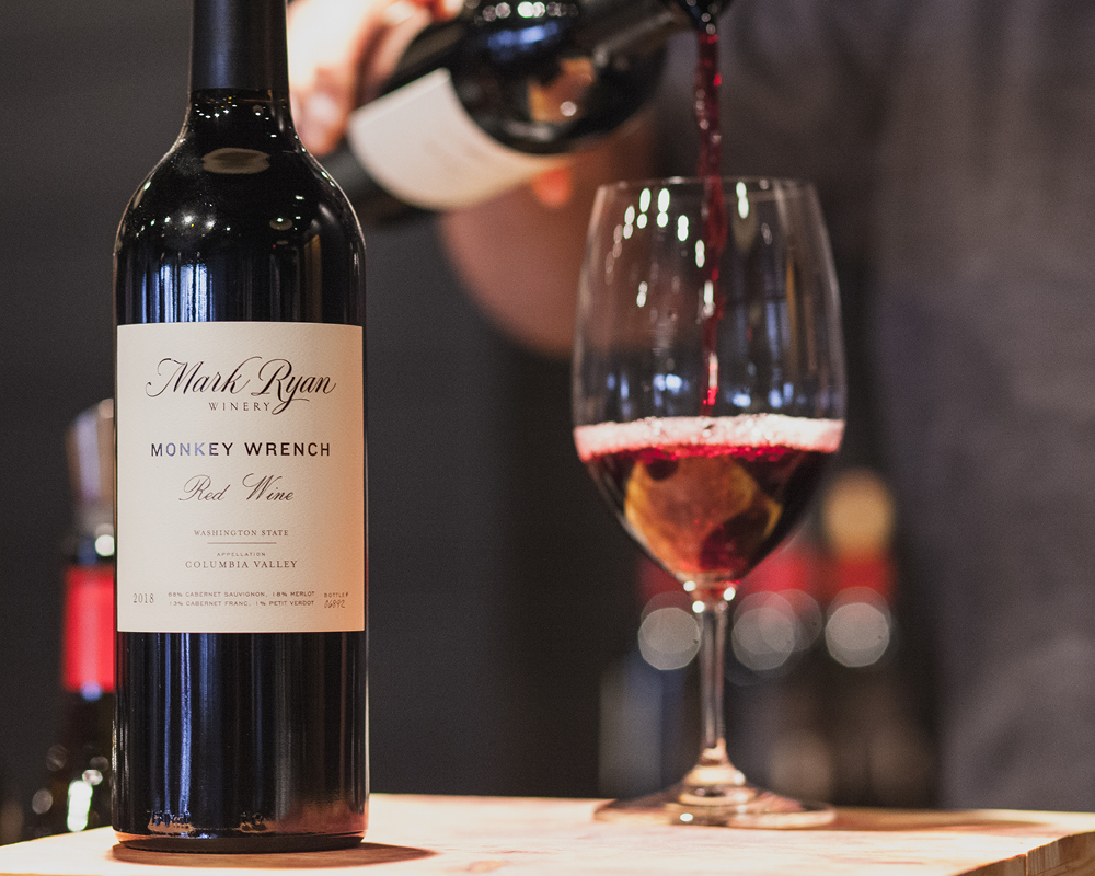 Monkey Wrench red wine bottle and glass being poured.