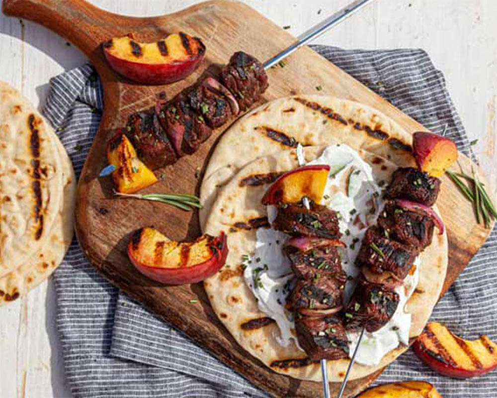 beef kabobs with peaches and pita bread