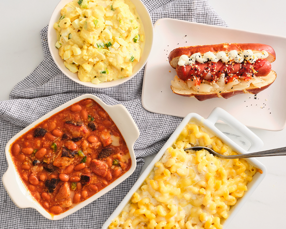 Potato salad, baked beans, hot dog, and mac and cheese