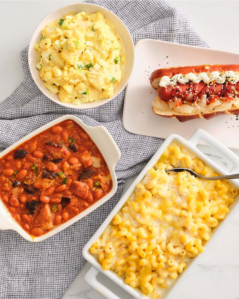 Potato salad, baked beans, hot dog, and mac and cheese