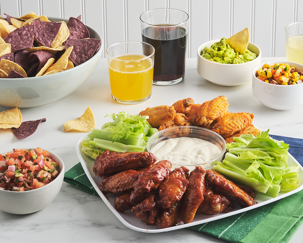 Chicken wing tray, dips, drinks, and chips