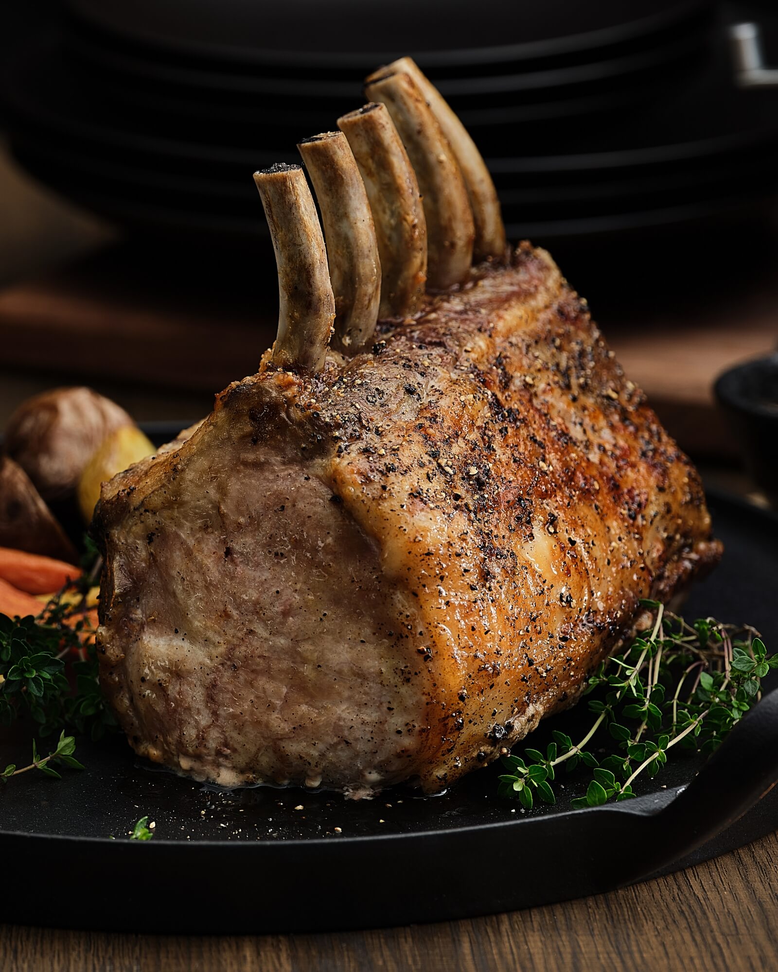 Roasted Pork with Garnishes on Dark Plate